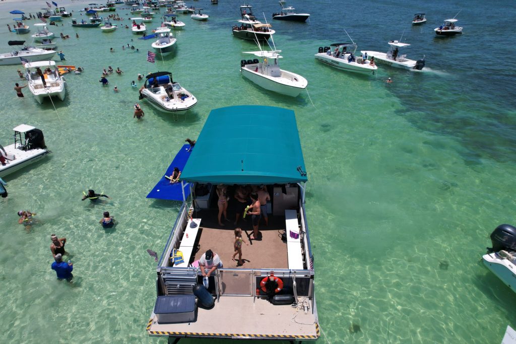 Aerial view of the party boat anchored at a busy sandbar among other boats